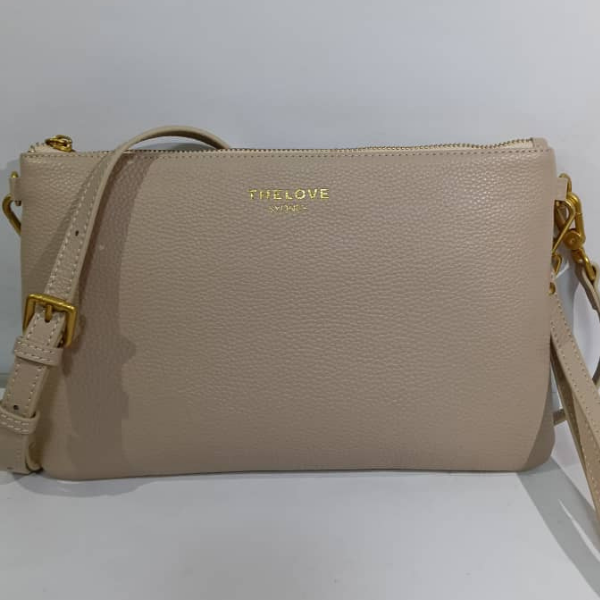 Beige handbag with gold accents on a white background