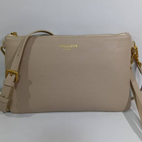 Beige handbag with gold accents on a white background
